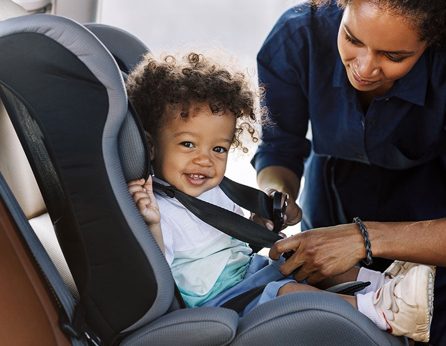 Certified Technician performing a car seat safety check at Matick Chevrolet