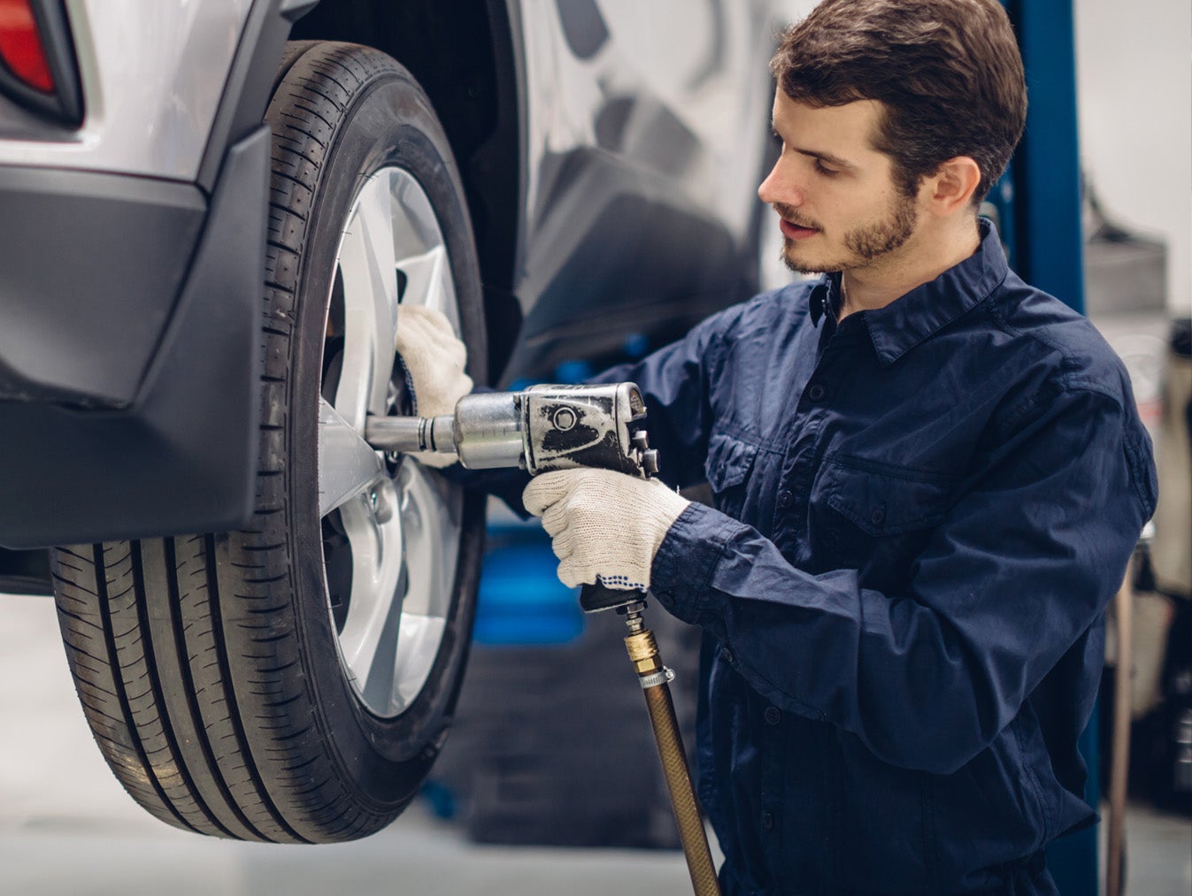 Mechanic working on tire alignment - George Matick Chevrolet in Redford MI